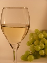 White wine in a glass with grapes