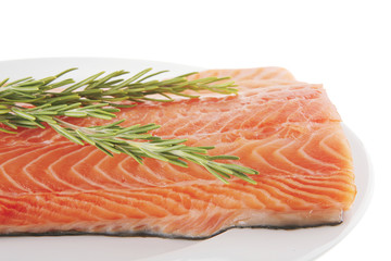 salmon fillet on white plate and rosemary