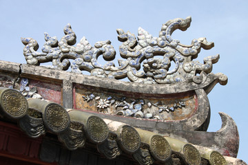 ancient art on roof of The Imperial Enclosure of Hue City
