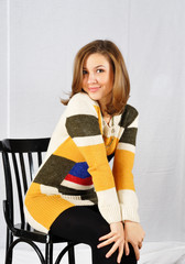 Beautiful smiling posing girl sitting on chair