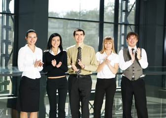 Obraz premium Five young business persons in a modern office