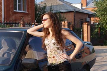 beautiful girl near a car