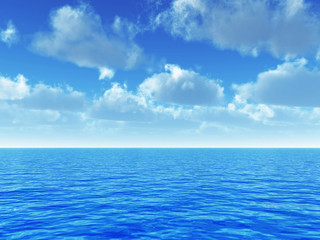 cloudy blue sky above a blue surface of the sea