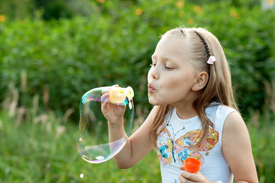 Cute Little Girl blowing bubbles