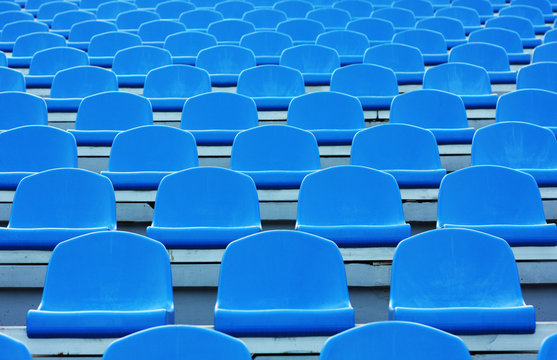 Empty blue plastic stadium seats