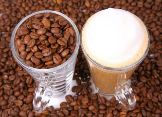 Caffe latte, glass of coffee beans surrounded by coffee beans