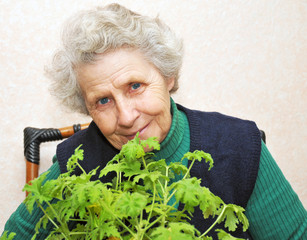 granny behind bouquet of green leafs