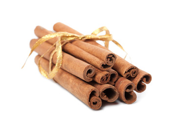 cinnamon with golden ribbon isolated