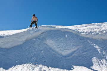 Naklejka na ściany i meble Man on the snow top.
