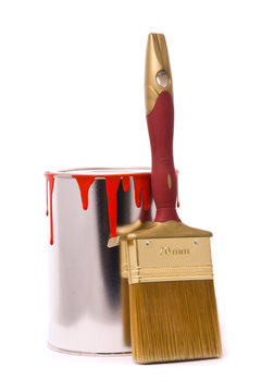 Can of red paint and professional brush on a white.