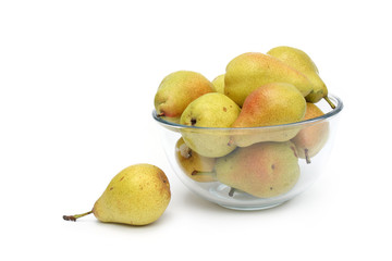 yellow pears on glass dish with one pear aside