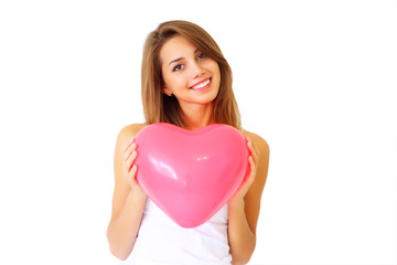 smiling girl holding a large decorative heart