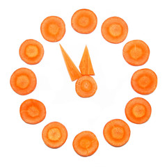 Clock made of carrots circle. Five minutes to midnight