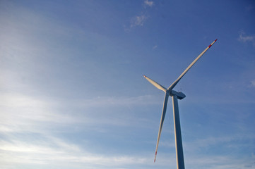 Wind turbine under blue sky