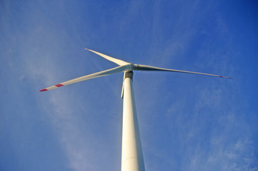 Wind turbine under blue sky