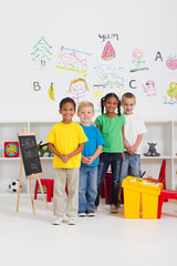 happy kindergarten classmates in classroom