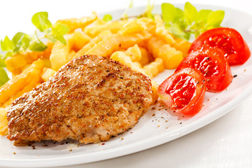 Fried pork chop with chips and vegetables