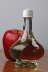 Bottle with apple vinegar and fresh apple. Shallow dof