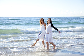 Two funny sisters on the beach.