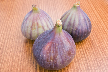 Fototapeta premium Three delicious fresh ripe figs close-up