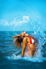 splashes. Girl in the sea