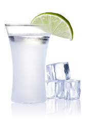 shot glass filled with clear cold alcohol