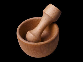 Wooden mortar and pestle on black