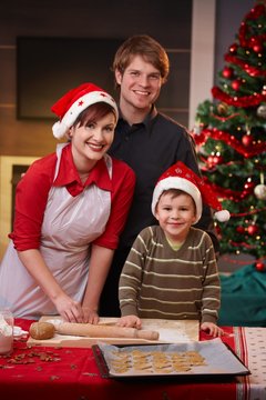 Happy family baking christmas cake together