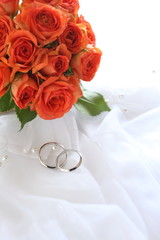 Wedding rings and rose bouquet