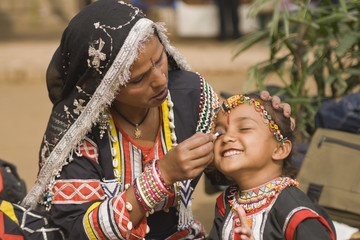 Young Rajasthani dancer gets make-up applied