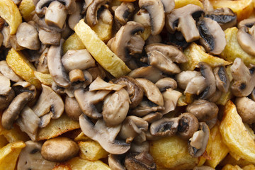 Roast  with baked potatoes and mushrooms , close-up