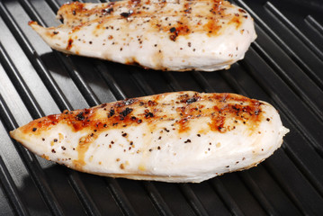 two grilled chicken breasts