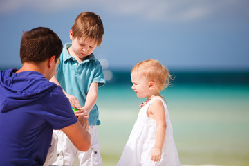 Father and kids making soap bubbles