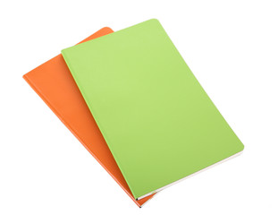Orange and green writing-books on a white background