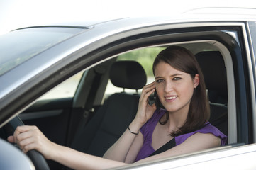 Fototapeta na wymiar Autofahrerin telefoniert während der Fahrt