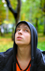 Fototapeta premium pensive teenager stand in the park