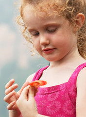 A Little Girl Finds a Pretty Orange Seashell