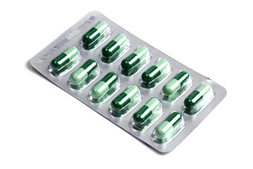 Package of green capsules  isolated on white