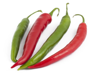 Two green and two red chili peppers on white