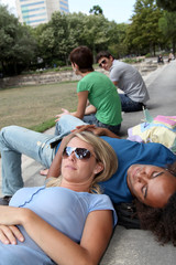 Students resting in  park during summer