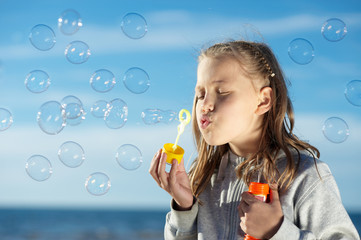 Little Girl blowing bubbles