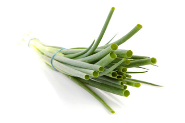 bunch of fresh spring onions over white background