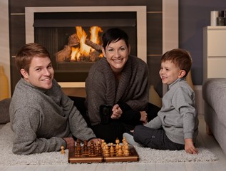 Happy family playing chess