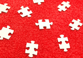 Puzzle on a red fabric
