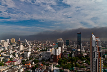 Cityscape covered with black fire smoke.