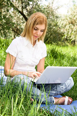 Woman with laptop in park