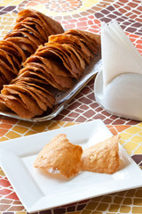 Pastry cakes with nuts on plate.
