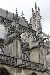 Details of Gothic Basilique Notre-Dame  of Alencon on cloudy day