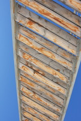 Wooden steps of the stairs against a blue sky