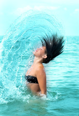 splashes. Girl in the sea